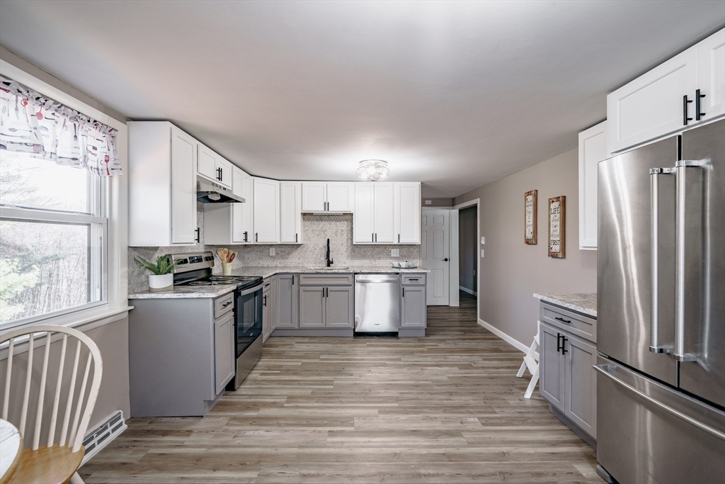 172 Bumstead Road Monson, MA 01057 - Photo 11 of 36 a kitchen with a refrigerator stove and wooden floor