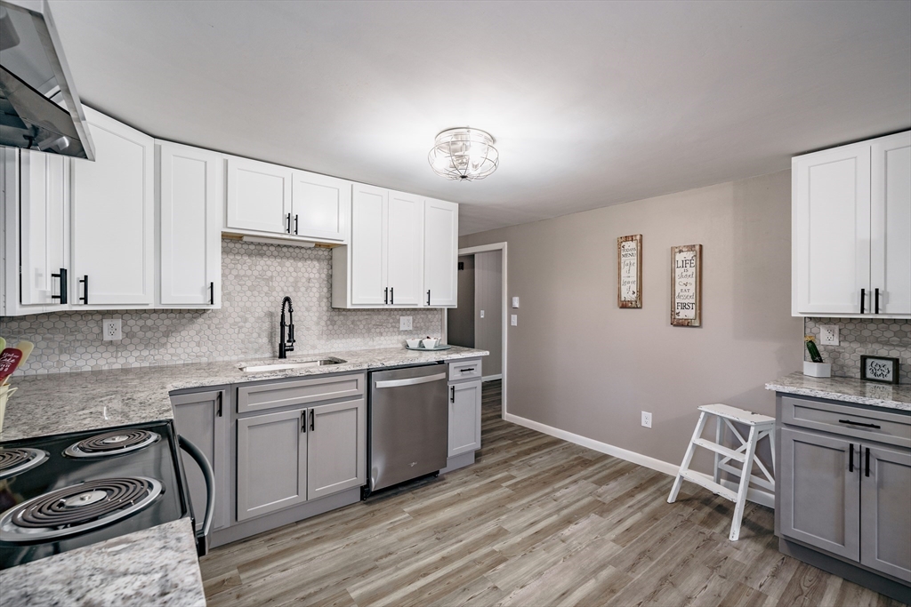 172 Bumstead Road Monson, MA 01057 - Photo 13 of 36 a kitchen with a sink a stove cabinets and wooden floor