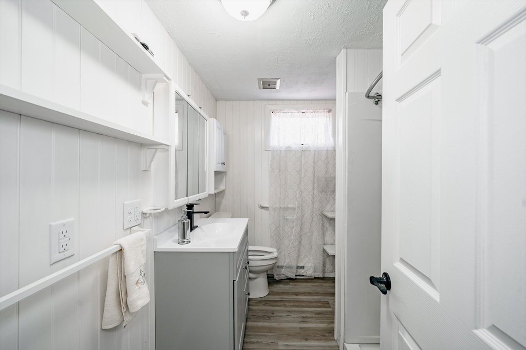 172 Bumstead Road Monson, MA 01057 - Photo 15 of 36 a bathroom with a sink a mirror and shower