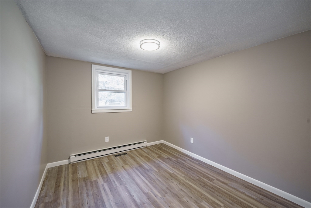 172 Bumstead Road Monson, MA 01057 - Photo 17 of 36 wooden floor in an empty room with a window