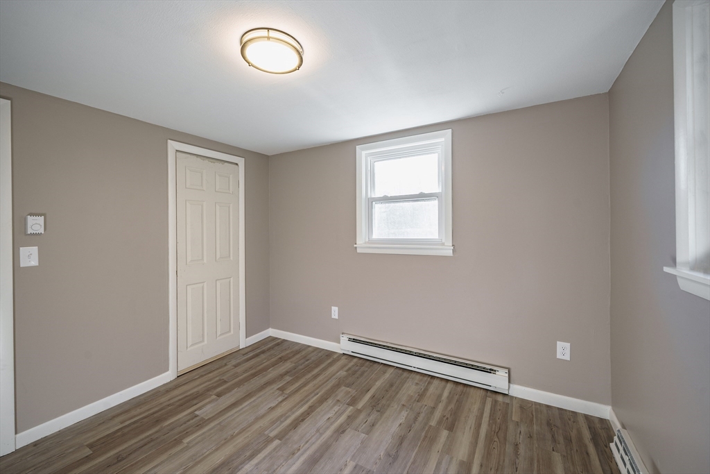 172 Bumstead Road Monson, MA 01057 - Photo 20 of 36 an empty room with wooden floor and windows