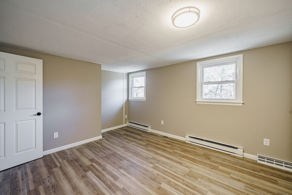 172 Bumstead Road Monson, MA 01057 - Photo 23 of 36 a view of room with window and wooden floor