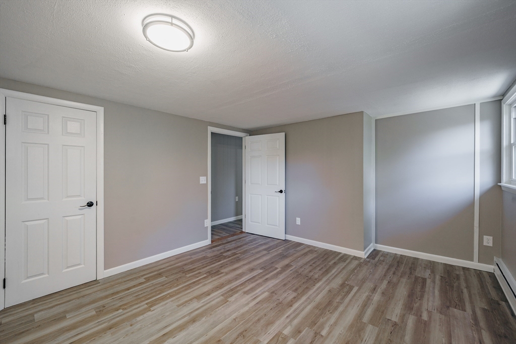 172 Bumstead Road Monson, MA 01057 - Photo 24 of 36 an empty room with wooden floor and windows
