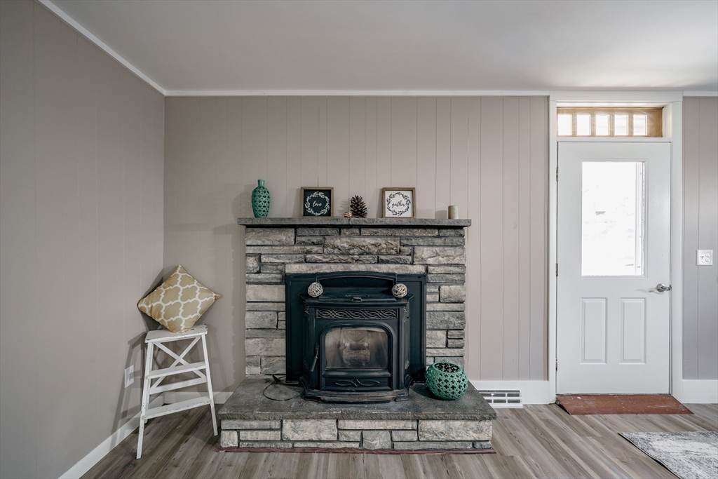 172 Bumstead Road Monson, MA 01057 - Photo 3 of 36 a living room with a fireplace and wooden floor