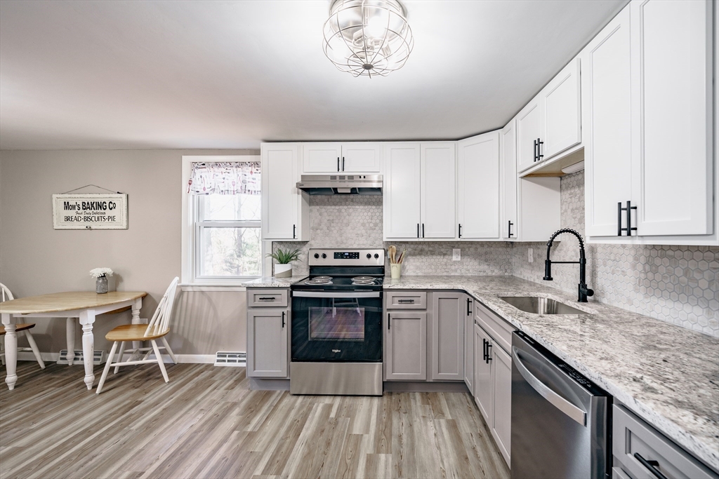 172 Bumstead Road Monson, MA 01057 - Photo 7 of 36 a kitchen with a stove a sink and cabinets