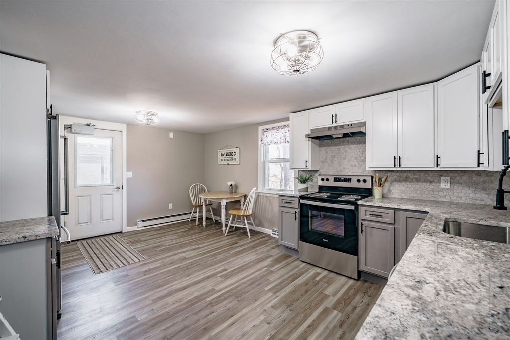 172 Bumstead Road Monson, MA 01057 - Photo 8 of 36 a kitchen with a stove and a refrigerator