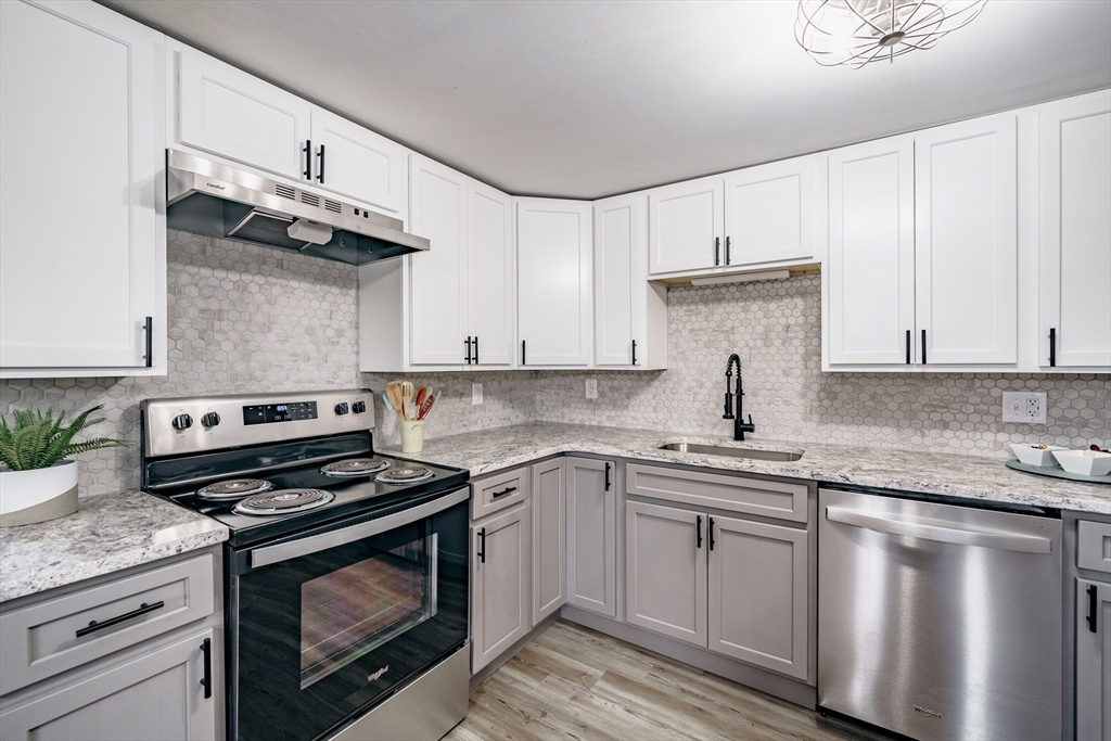 172 Bumstead Road Monson, MA 01057 - Photo 9 of 36 a kitchen with granite countertop a sink stainless steel appliances and white cabinets