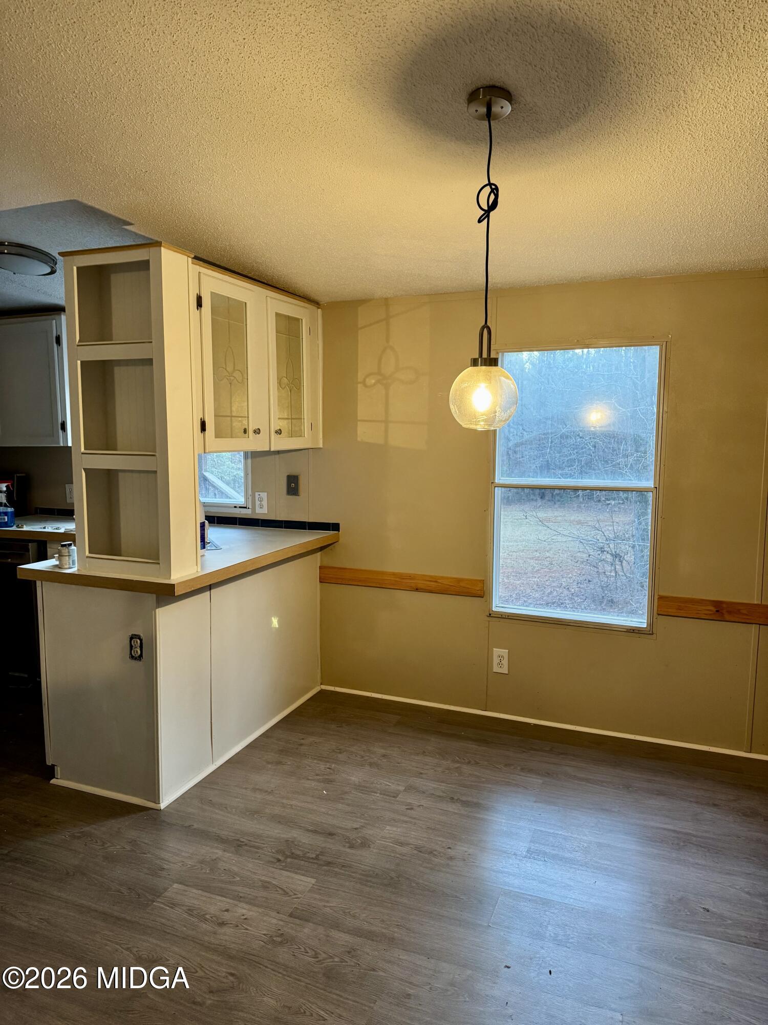 197 Cherokee Trail Forsyth, GA 31029 - Photo 4 of 9 a kitchen with a sink cabinets and wooden floor
