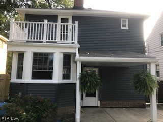 14414 Alger Road Cleveland, OH 44111 - Photo 29 of 33 Back of home in summer, showcasing balcony and covered patio.