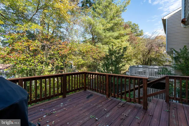 a view of balcony with wooden floor and fence