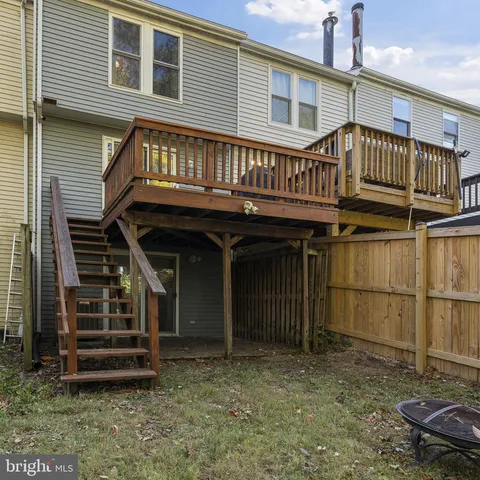 a view of a house with a window and wooden deck