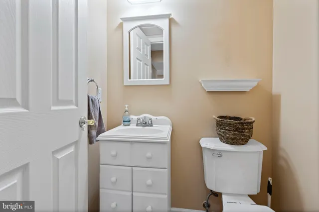 a bathroom with a toilet a sink and mirror