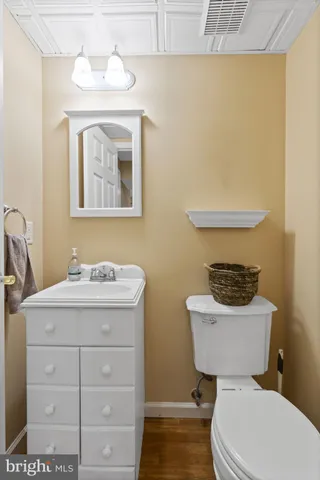 a bathroom with a toilet a sink and mirror