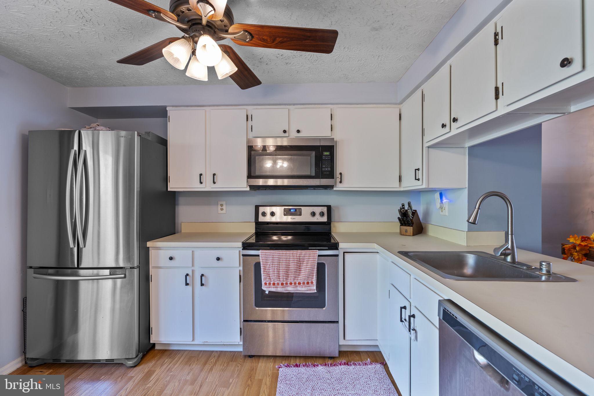 38 Trailwood Road Nottingham, MD 21236 - Photo 3 of 36 a kitchen with stainless steel appliances granite countertop a refrigerator a stove a sink and white cabinets