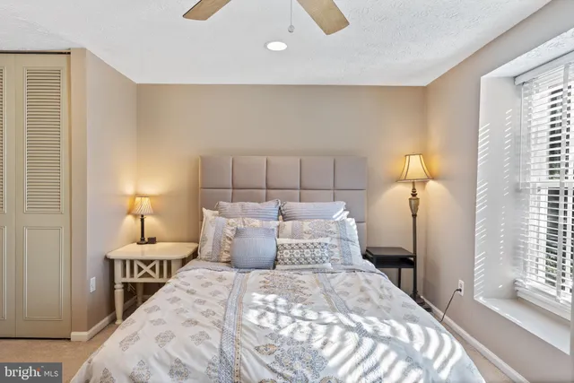 a bedroom with a bed and a lamp