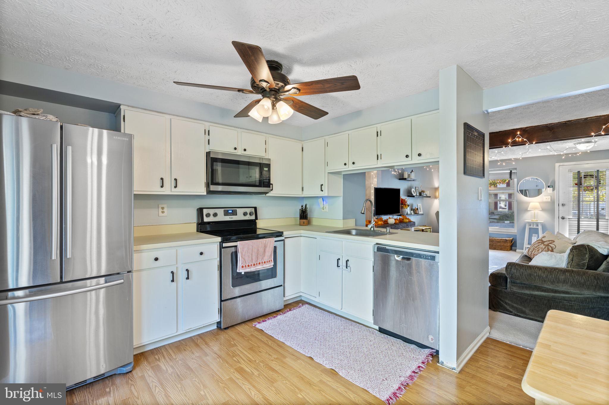 38 Trailwood Road Nottingham, MD 21236 - Photo 4 of 36 a kitchen with white cabinets and stainless steel appliances