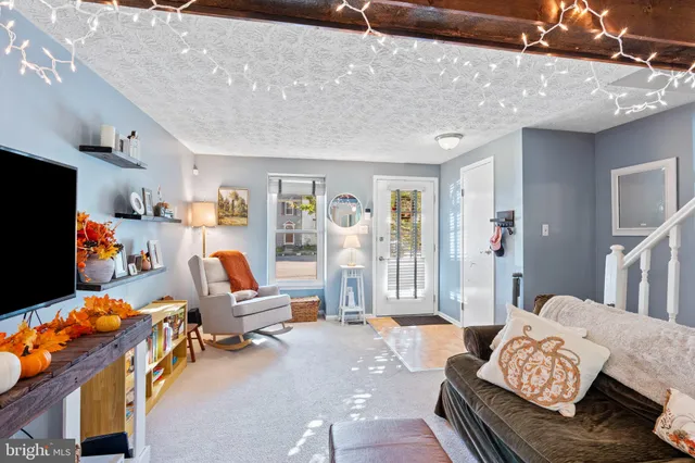 a bedroom with furniture and a flat screen tv