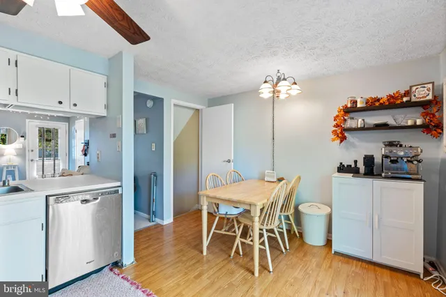 a dining room with furniture and wooden floor