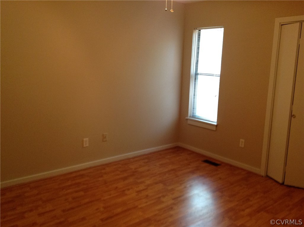 1500 Headwaters Road Midlothian, VA 23113 - Photo 5 of 9 an empty room with wooden floor and windows