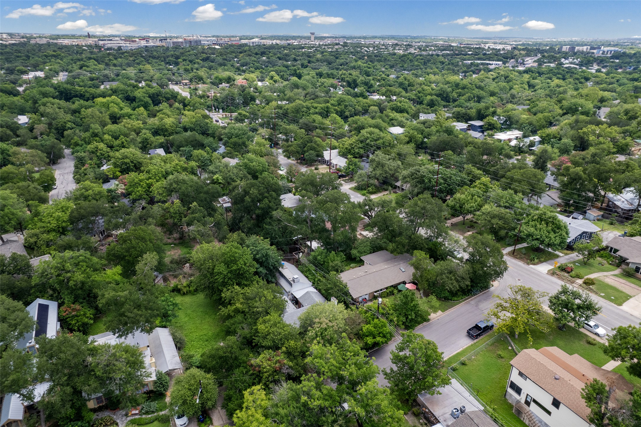 3302 Cherrywood Road Austin, TX 78722 - Photo 24 of 26 An aerial perspective reveals a verdant neighborhood with established trees and residential streets winding through.