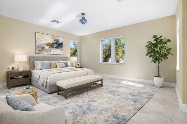 a bedroom with a bed and a chandelier