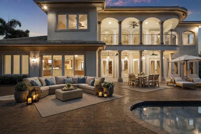 a living room with furniture chandelier and a fireplace