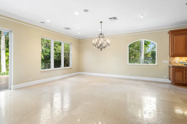 a spacious bathroom with a granite countertop sink a toilet and a mirror