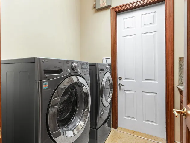 a front view of a house with garden and trees