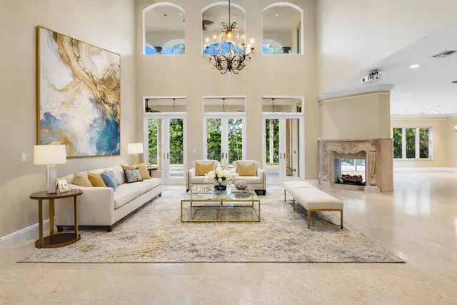 a living room with furniture flat screen tv and a large window