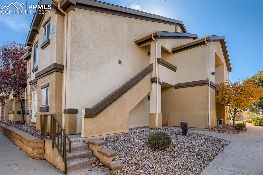 a view of a house with more windows and potted plants