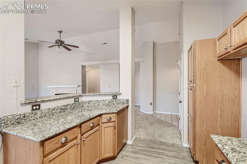 3780 Riviera Grove, Unit 204 Colorado Springs, CO 80922 - Photo 15 of 33 a bathroom with a granite countertop sink and a mirror