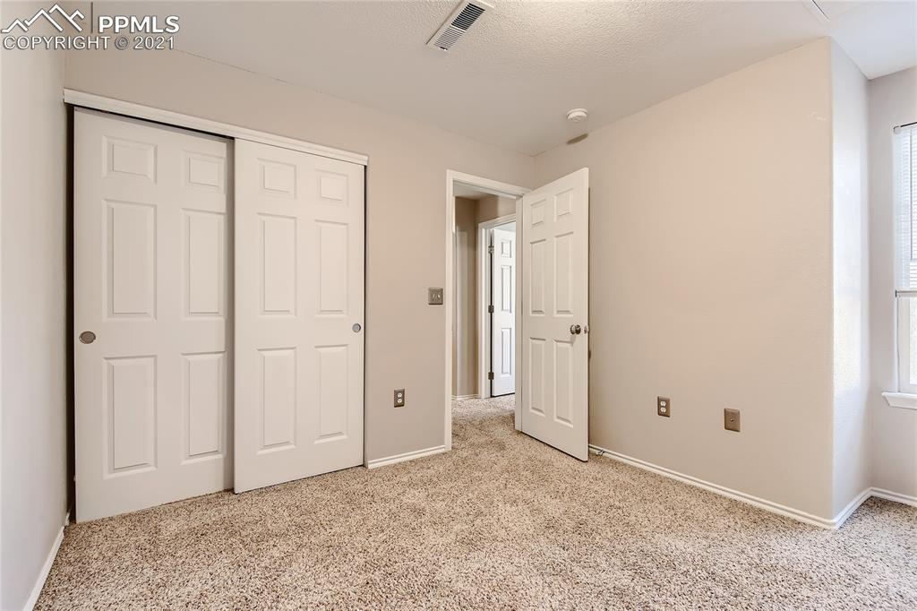 3780 Riviera Grove, Unit 204 Colorado Springs, CO 80922 - Photo 28 of 33 an empty room with windows and closet