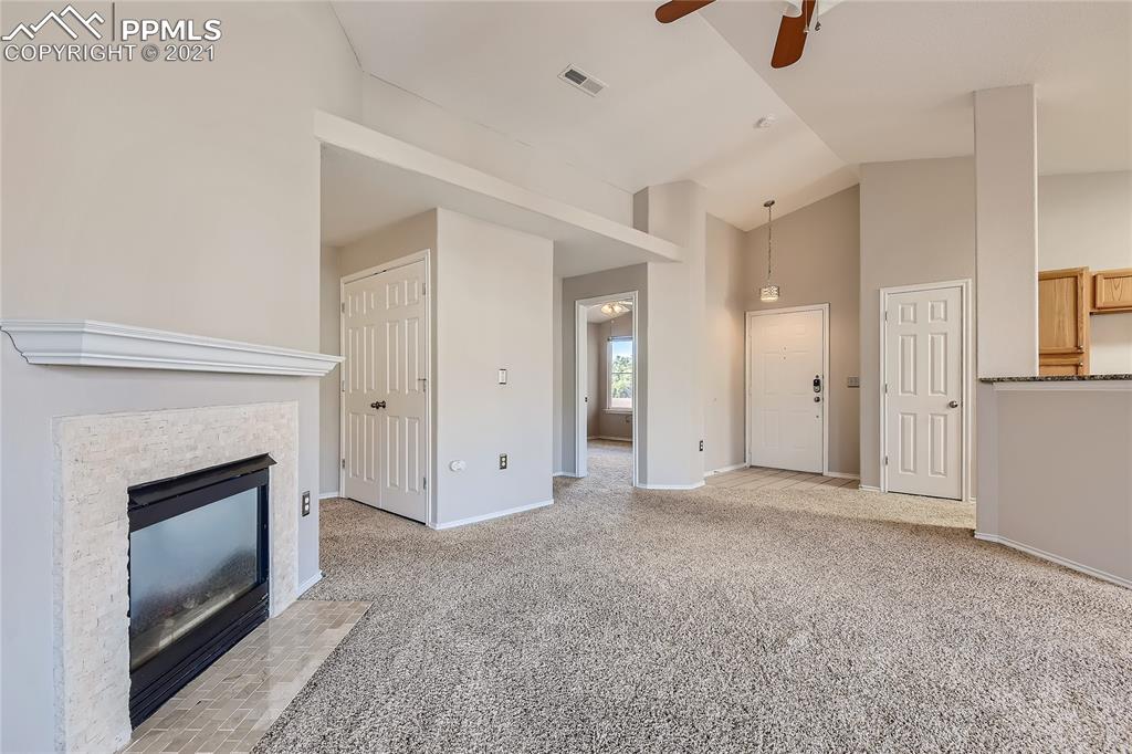 3780 Riviera Grove, Unit 204 Colorado Springs, CO 80922 - Photo 10 of 33 a view of empty room with a fireplace and window