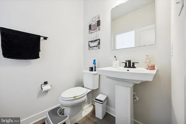 a bathroom with a sink a toilet and mirror