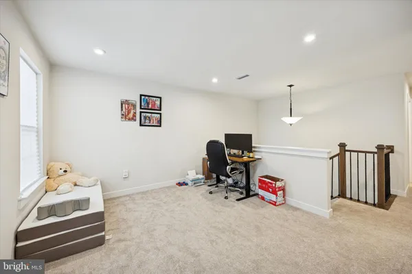 a view of a room with workspace and a window