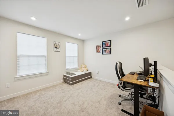 a view of a workspace with furniture and a window