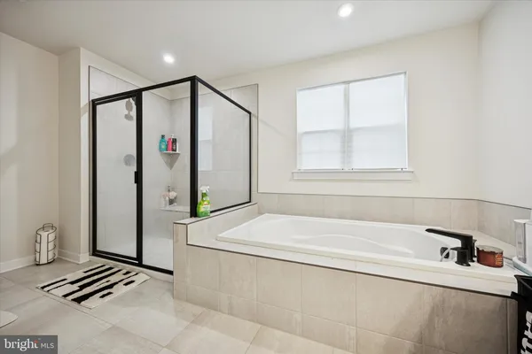 a bathroom with a bathtub and a shower