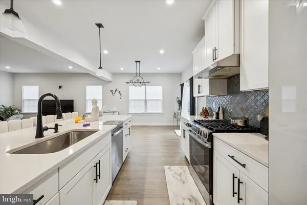 a kitchen with a sink stove and cabinets