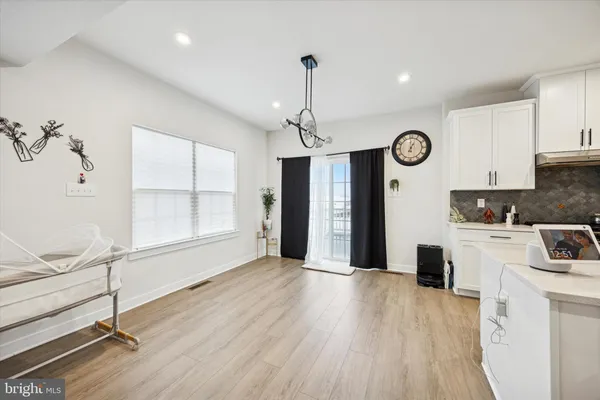 a open kitchen with cabinets stainless steel appliances and a ceiling fan