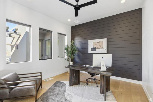 2197 Reserve Circle St. George, UT 84770 - Photo 34 of 57 Home office with wood walls, ceiling fan, recessed lighting, light wood-style floors, and an accent wall