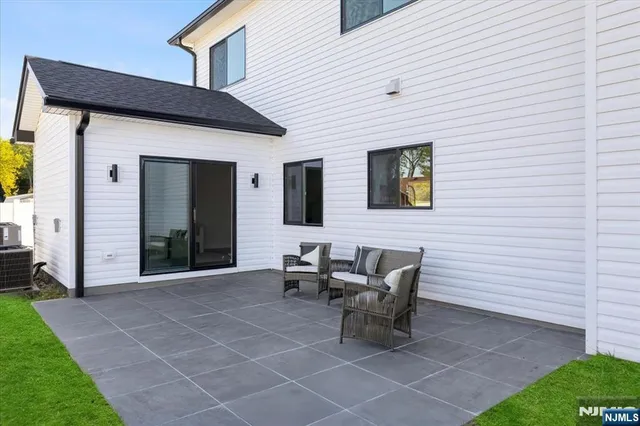 a dining room with wooden floor a chandelier a wooden table and chairs