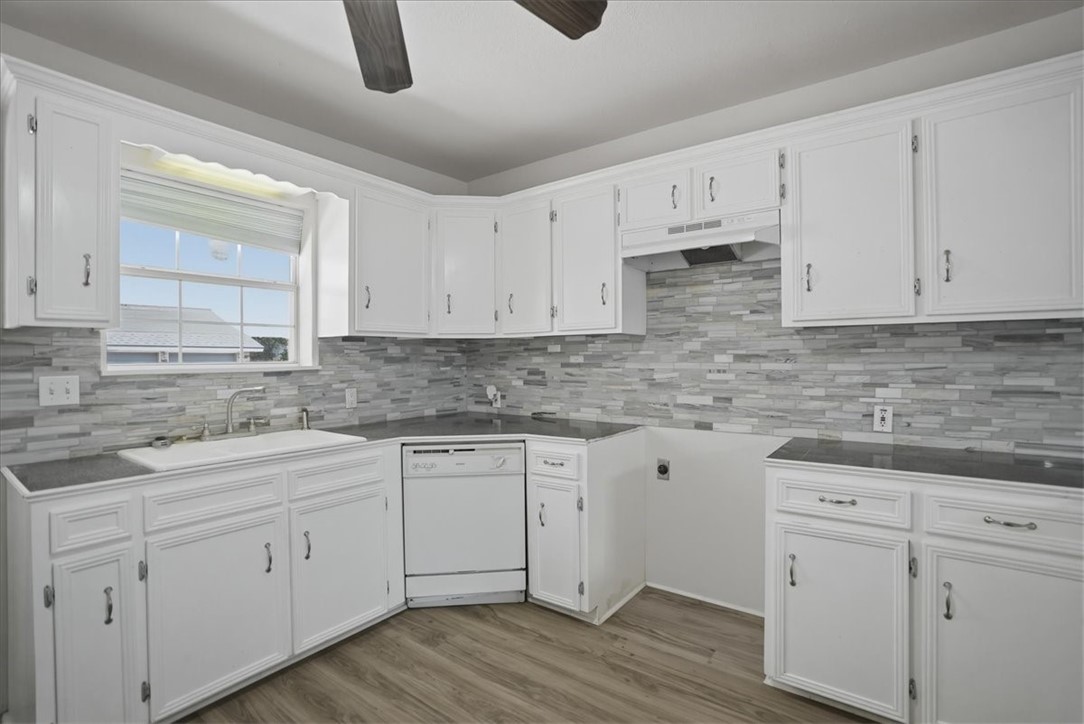 1601 Owens Avenue Three Rivers, TX 78071 - Photo 12 of 34 a kitchen with white cabinets granite counter tops and a sink