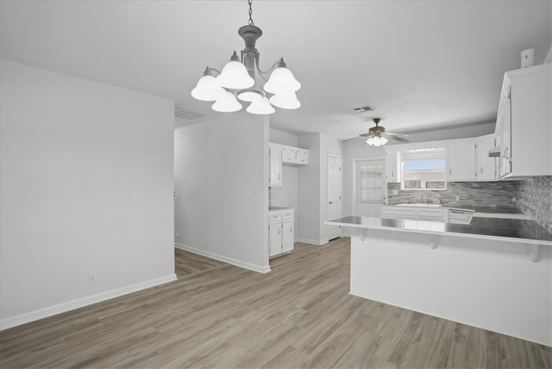 1601 Owens Avenue Three Rivers, TX 78071 - Photo 13 of 34 a view of a kitchen counter space and wooden floor