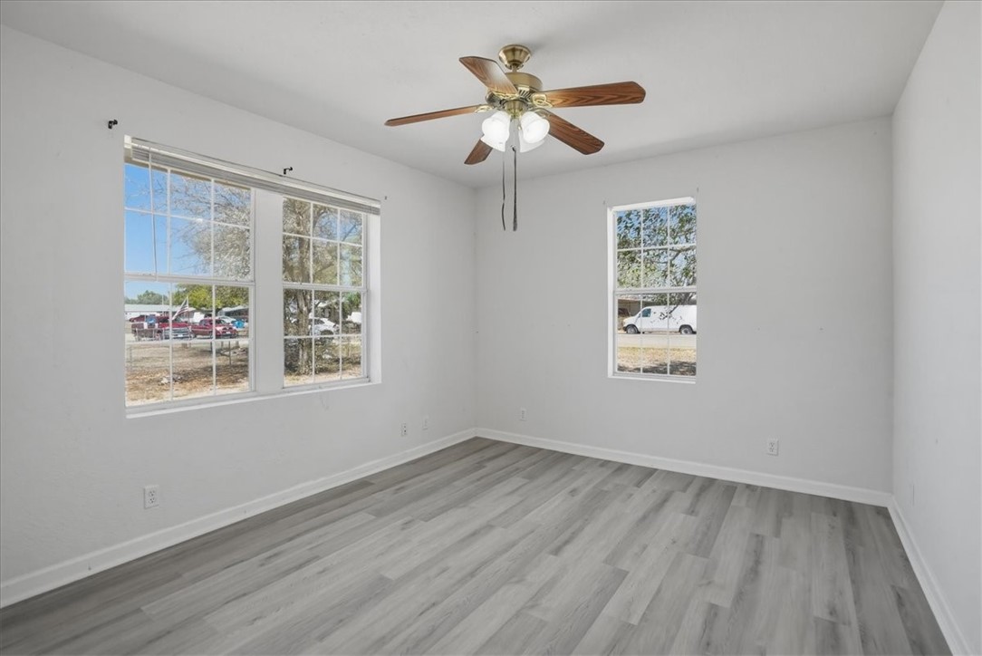 1601 Owens Avenue Three Rivers, TX 78071 - Photo 16 of 34 a view of an empty room with a window and wooden floor