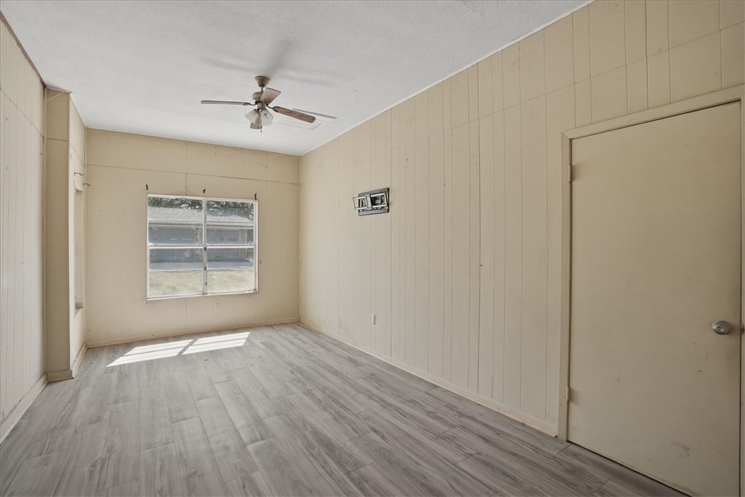 1601 Owens Avenue Three Rivers, TX 78071 - Photo 24 of 34 a view of an empty room with wooden floor and a window