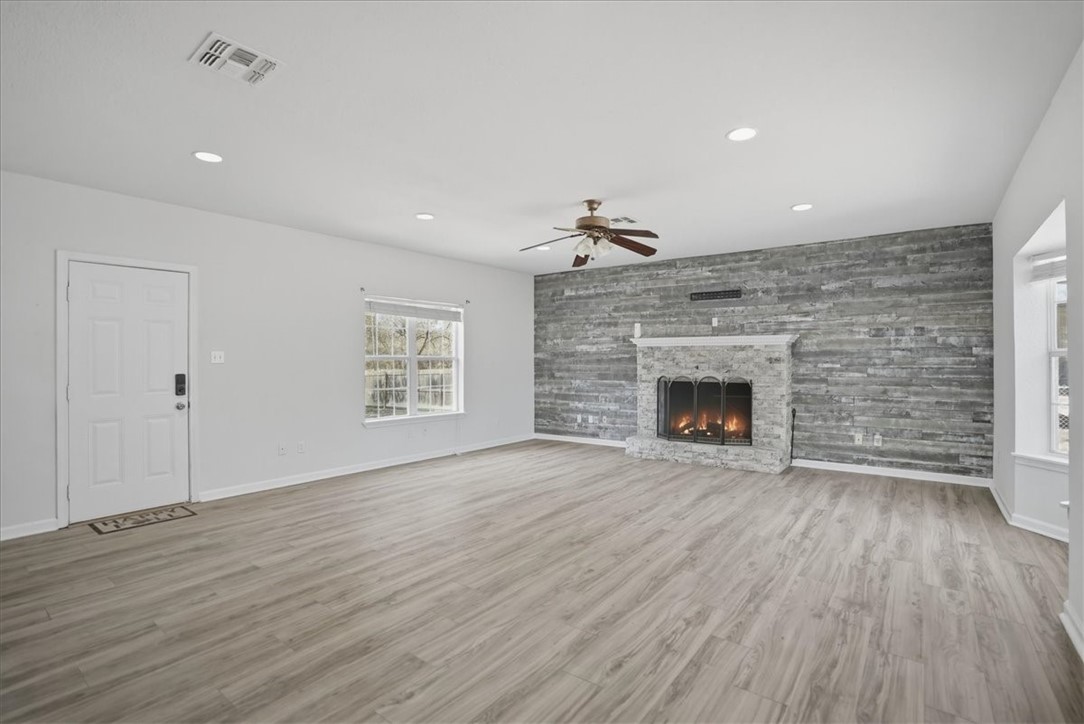1601 Owens Avenue Three Rivers, TX 78071 - Photo 5 of 34 an empty room with wooden floor fireplace and window