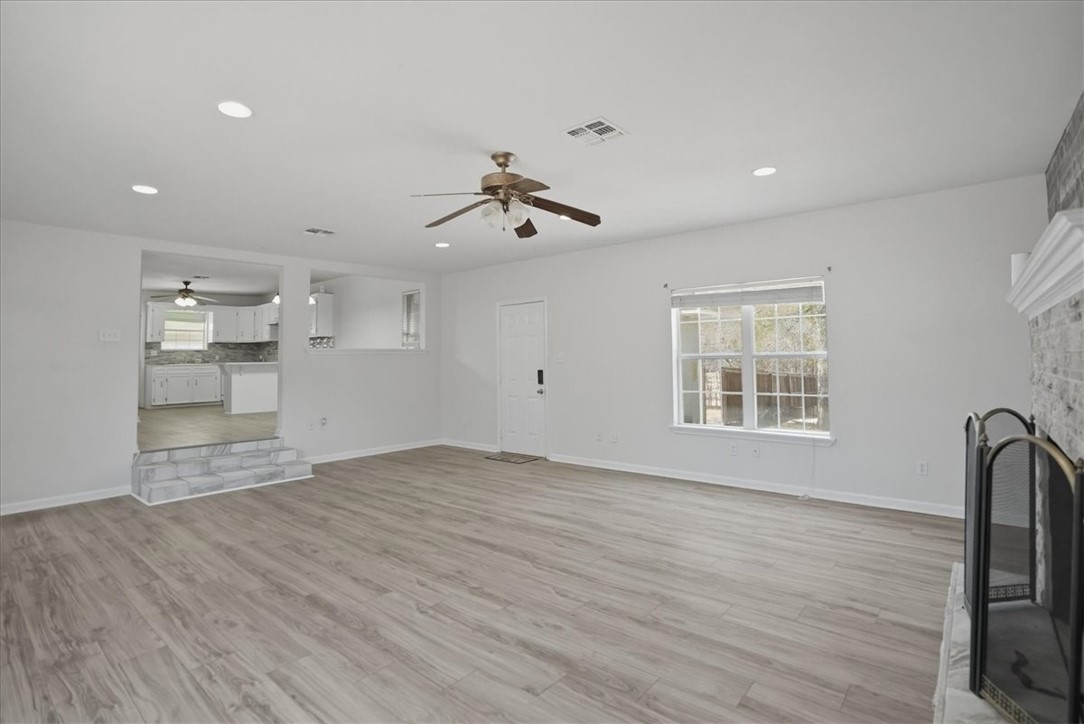 1601 Owens Avenue Three Rivers, TX 78071 - Photo 8 of 34 a view of an empty room with a window and wooden floor