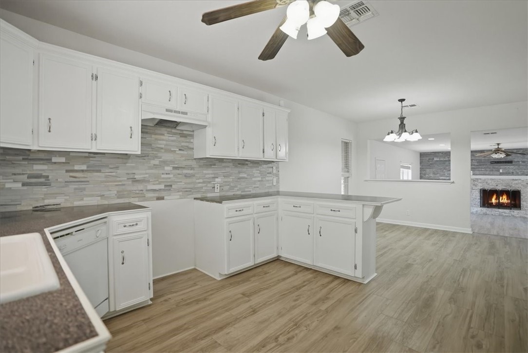 1601 Owens Avenue Three Rivers, TX 78071 - Photo 9 of 34 a kitchen with granite countertop white cabinets and white appliances