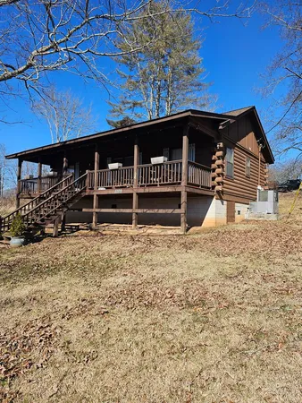 a backyard of a house with wooden fence and a bench