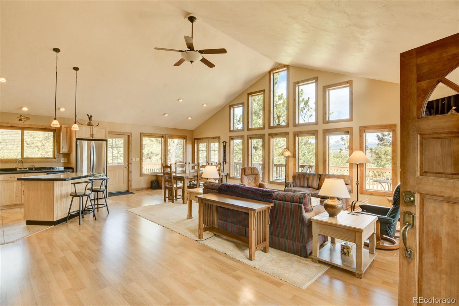 3296 Singletree Road Hartsel, CO 80449 - Photo 15 of 50 a living room with furniture large window and kitchen view